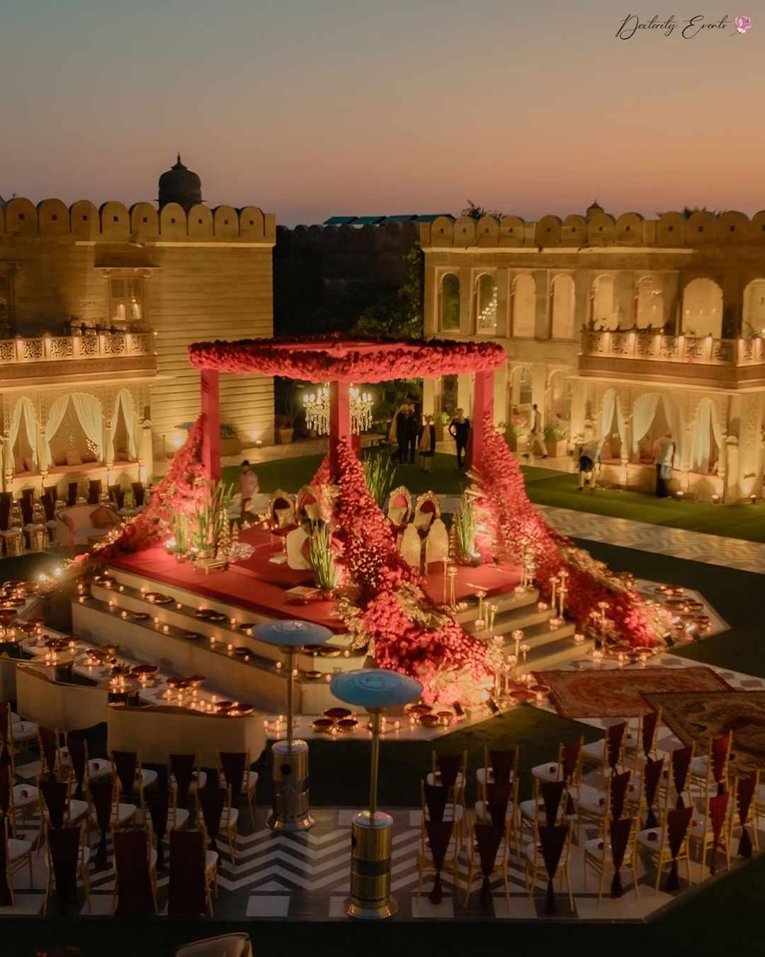 The mandap glowed under the soft shimmer of lights, flowers cascading like blessings from the heavens