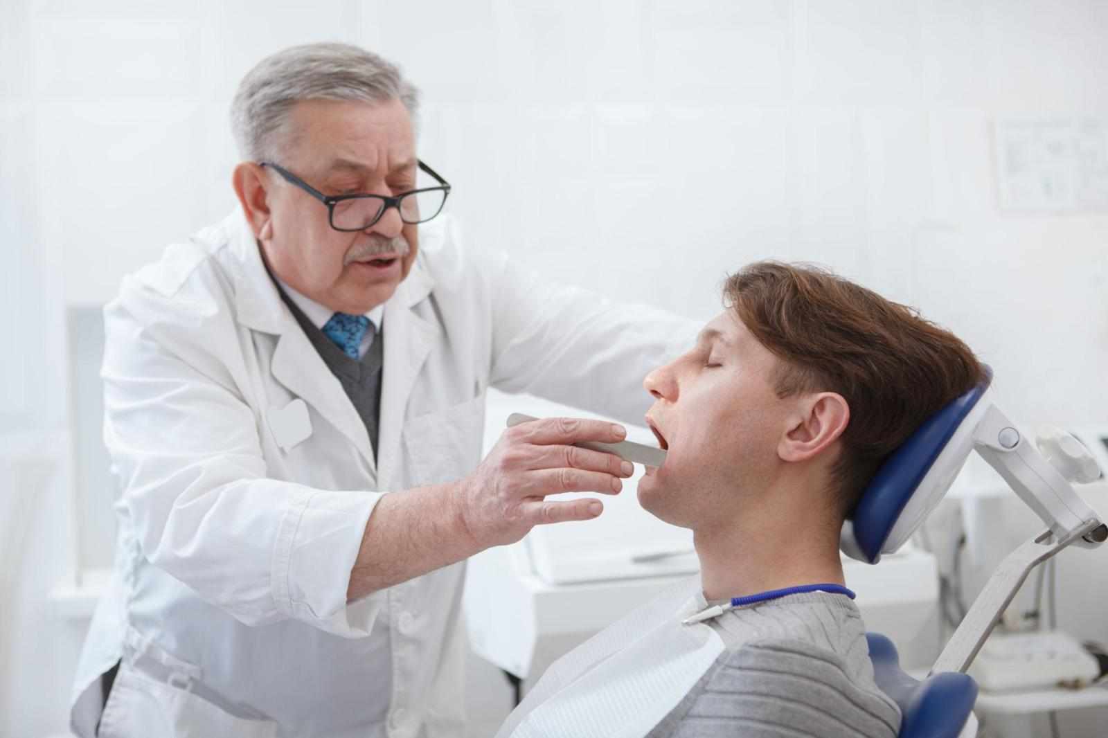 Man getting dental treatment by professional dentist