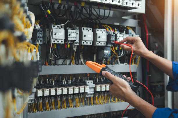 Electrician measurements with multimeter testing current electric in control panel, safety concept . Electrician measurements with multimeter testing current electric in control panel, safety concept .  electrician  stock pictures, royalty-free photos & images