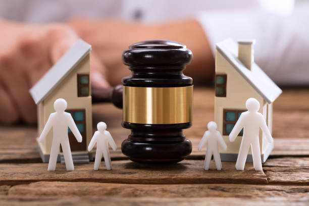 Close-up of mallet showing separation of family and house Close-up of mallet showing separation of family and house on wooden desk  divorce lawyer stock pictures, royalty-free photos & images
