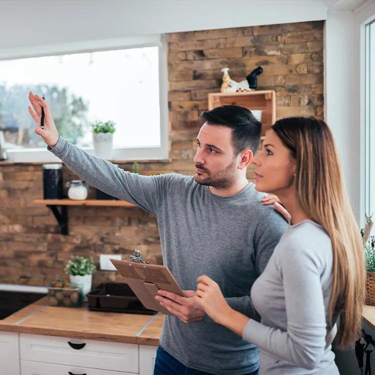 young couple in kitchen discussing renovation plans