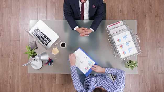 Top view of businessman analyzing financial documents discussing company strategy