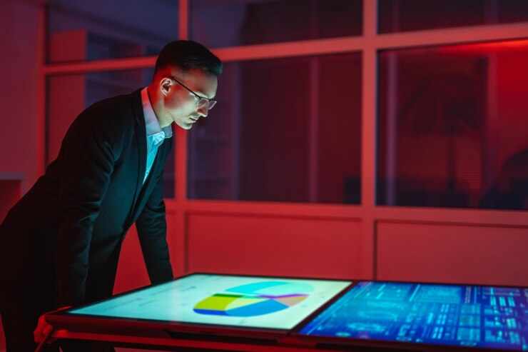 The man working with big displays in the dark room