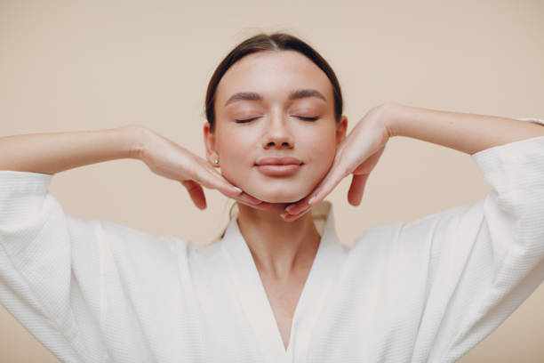 Young woman doing face building facial gymnastics self massage and rejuvenating exercises Young woman doing face building facial gymnastics self massage Facial treatments  stock pictures, royalty-free photos & images