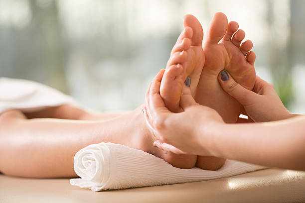 Close-up of reflexology Close-up of young woman having reflexology foot massage stock pictures, royalty-free photos & images