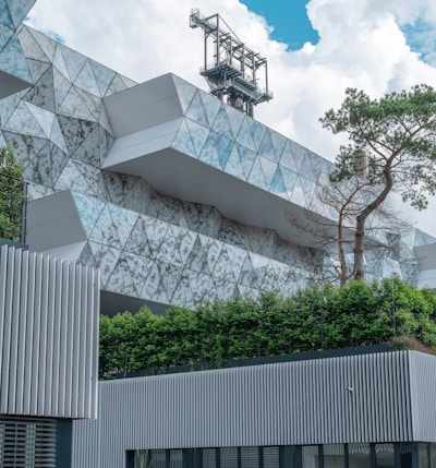 white concrete building near green trees during daytime
